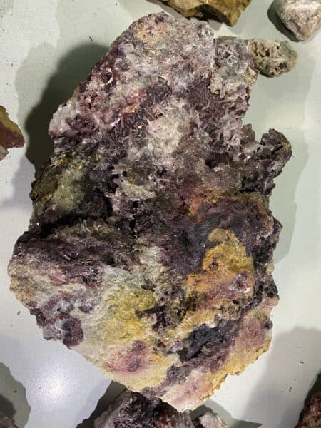 large colorful boulder with purples, pinks, and yellows